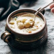 Gnocchi Soup in soup mug with spoon.