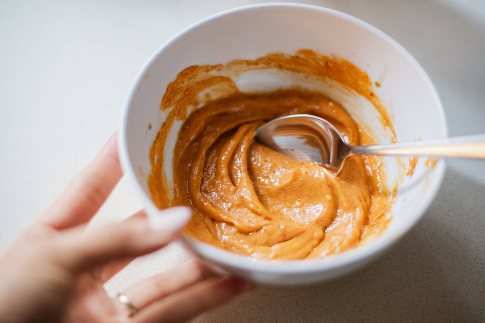 Mixing gochujang butter in a bowl.