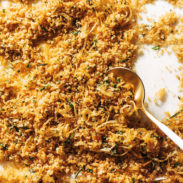 Crispy breadcrumbs on a sheet pan with a spoon.