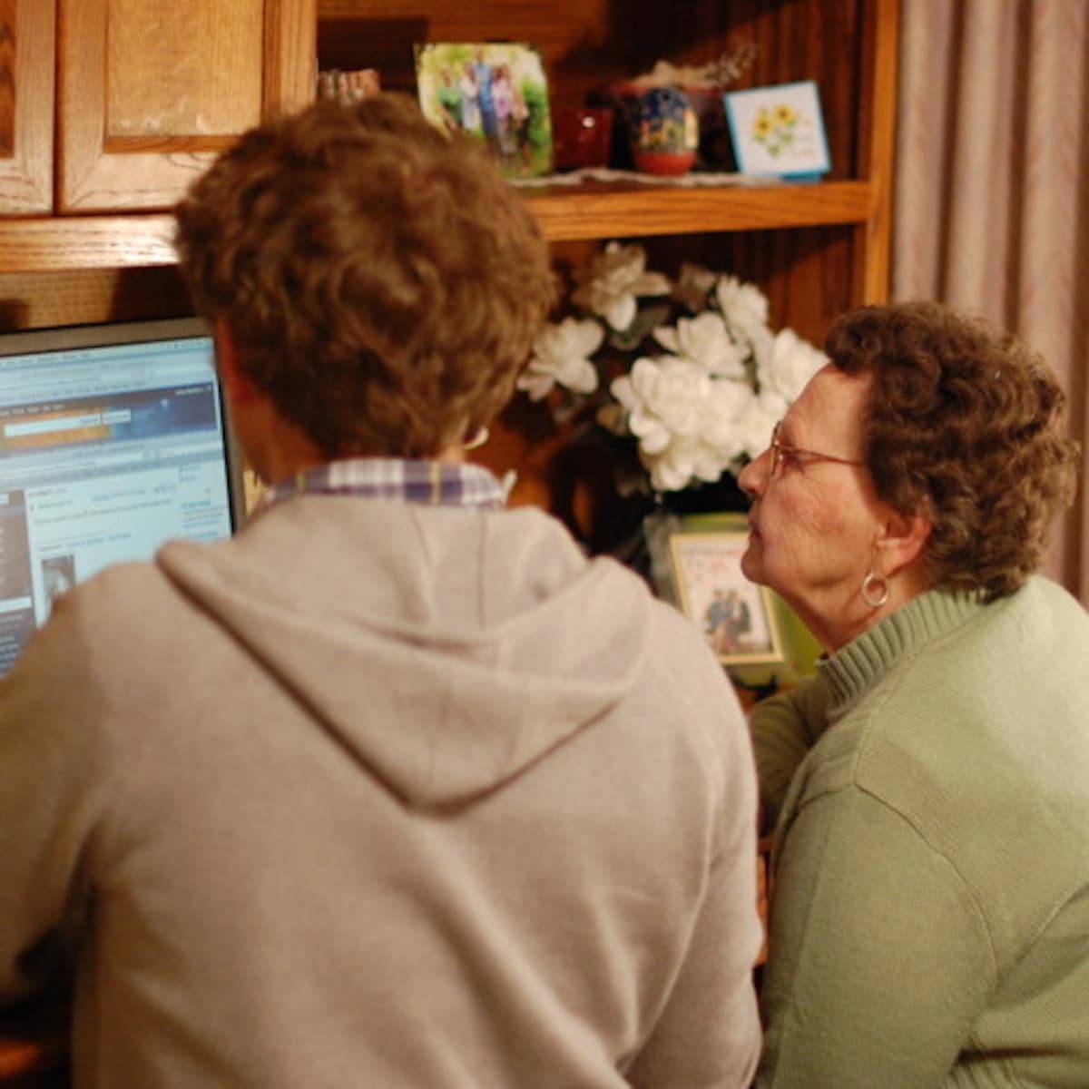 Two people looking at a computer screen.
