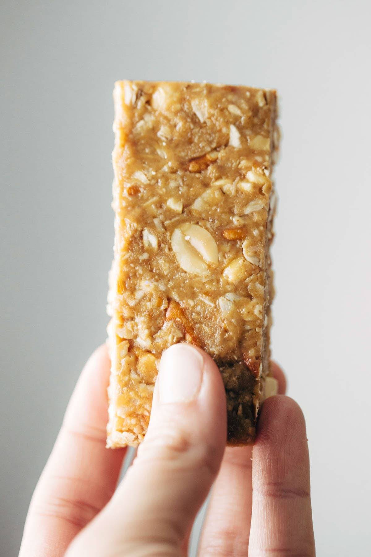 Soft granola bar held by hand.