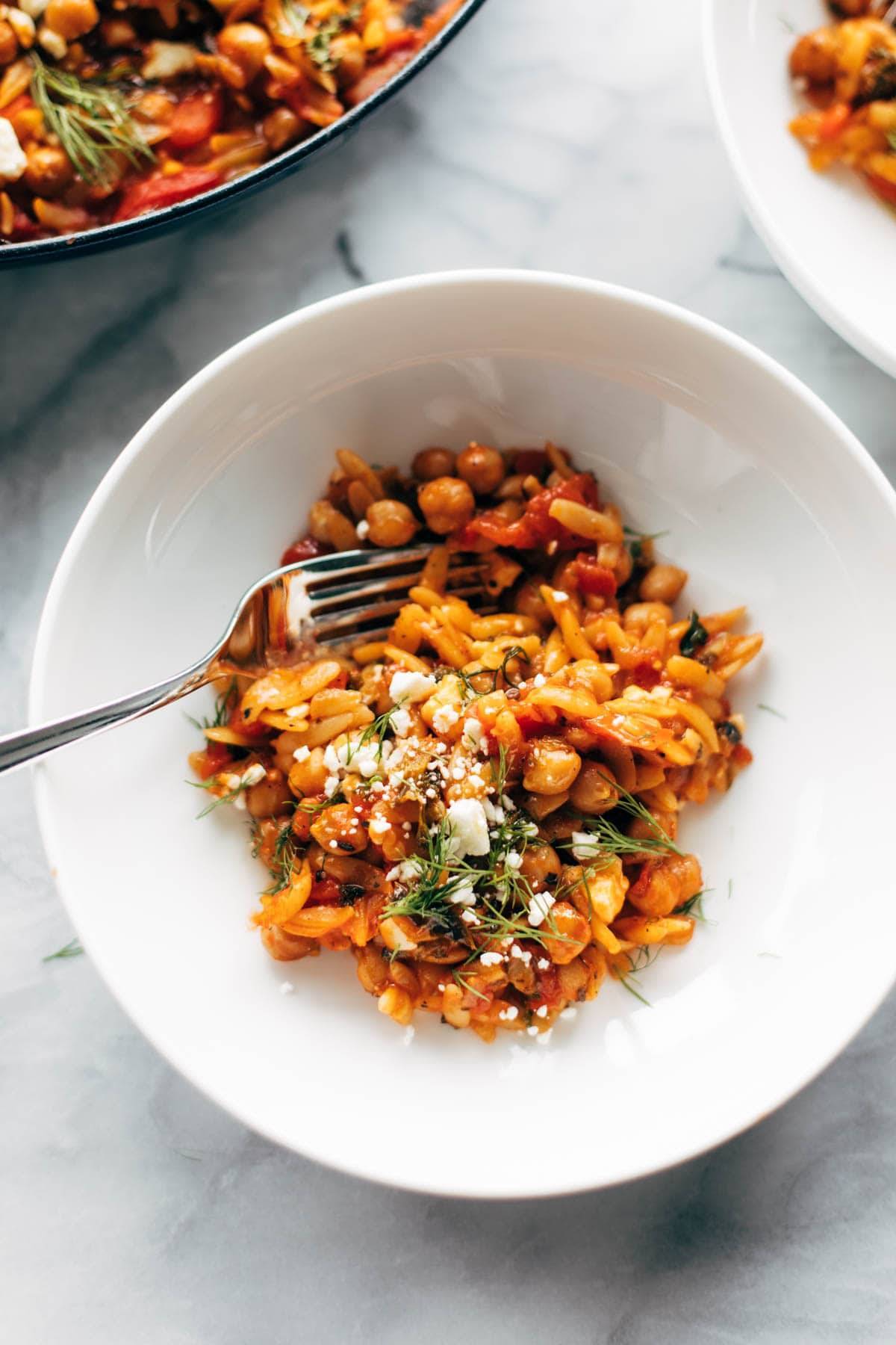 Greek Baked Orzo in a bowl with a fork.