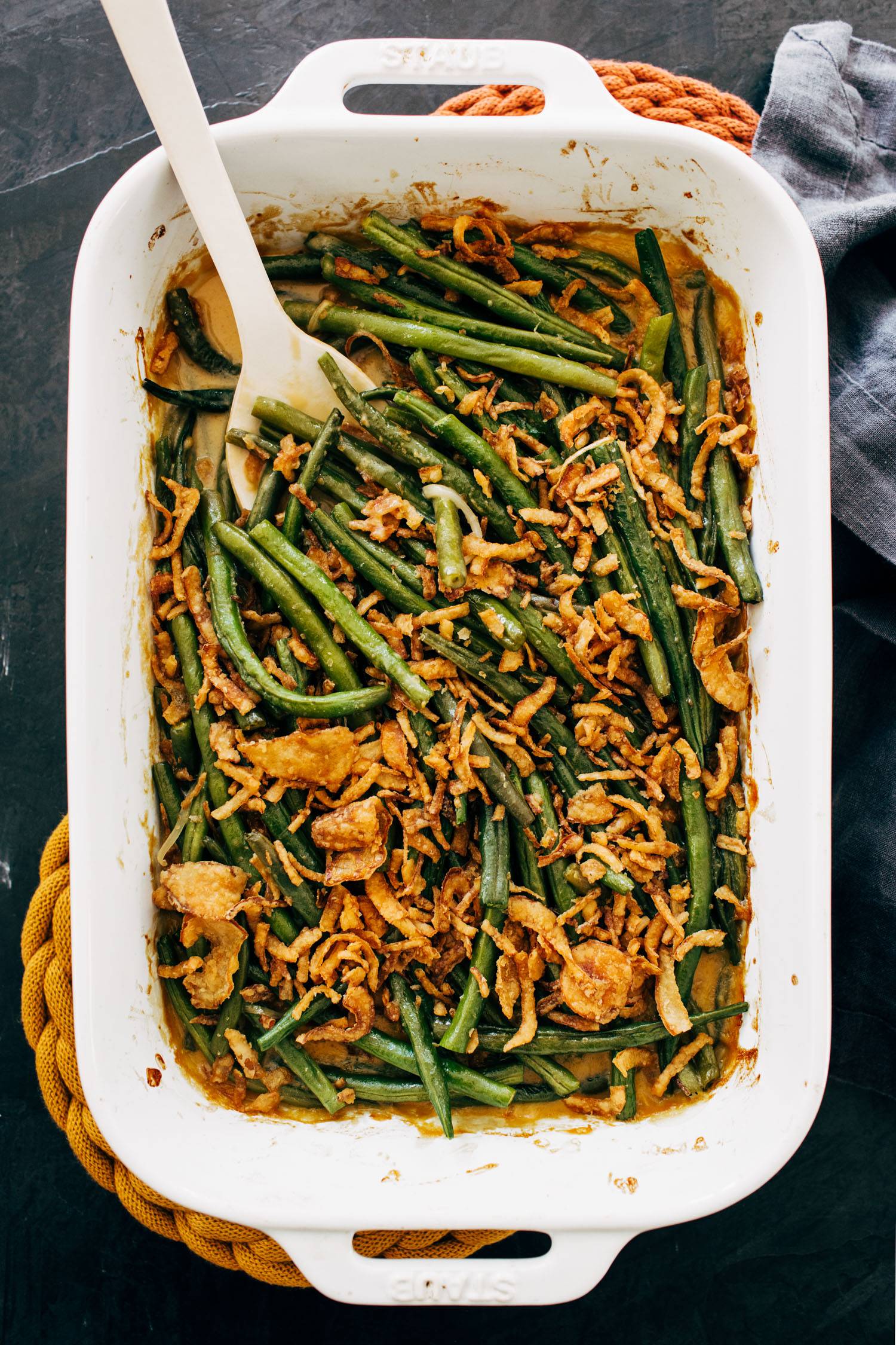 Green bean casserole in a pan with a spoon