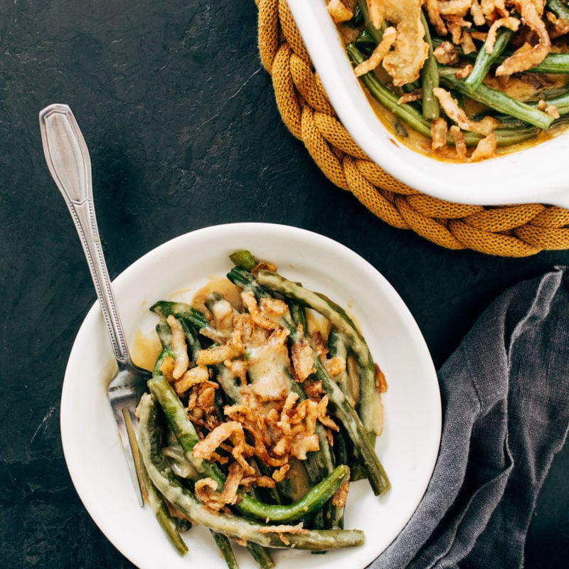 Green bean casserole on a plate with a fork.