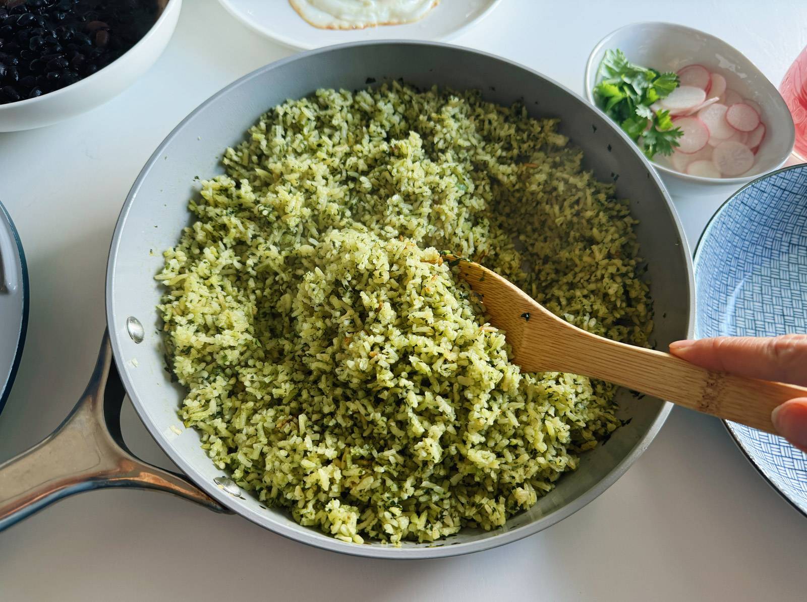 Cooked green rice in a skillet