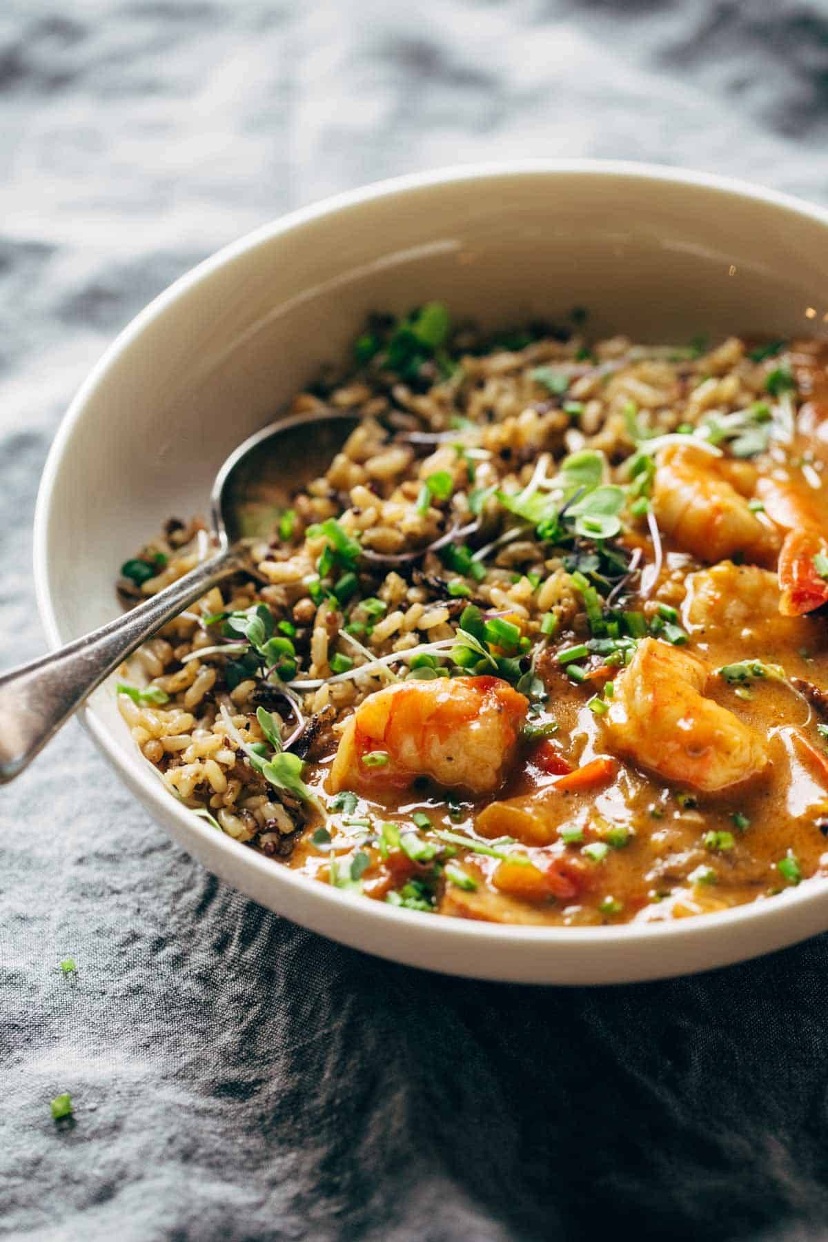 Shrimp and rice in a bowl with a spoon.