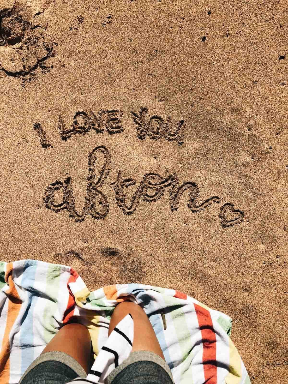 "I love you Afton" in the sand.