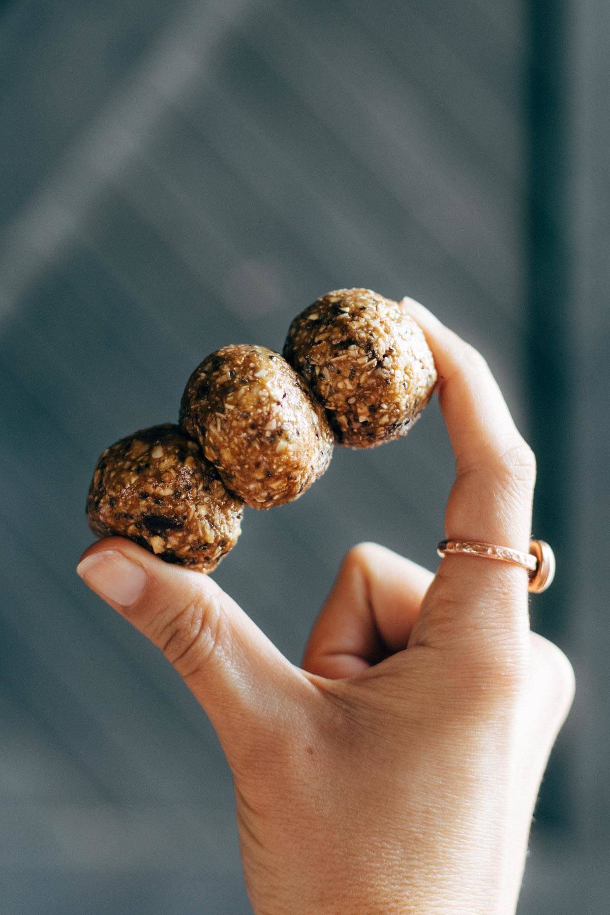 Cookie Dough Energy Bites held by hand.