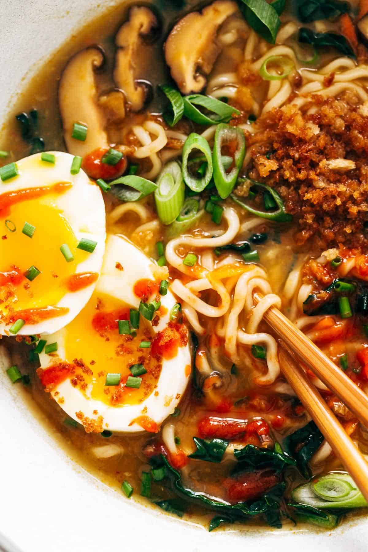 Close-up image of Quick Homemade Ramen with chopsticks and a soft egg. 