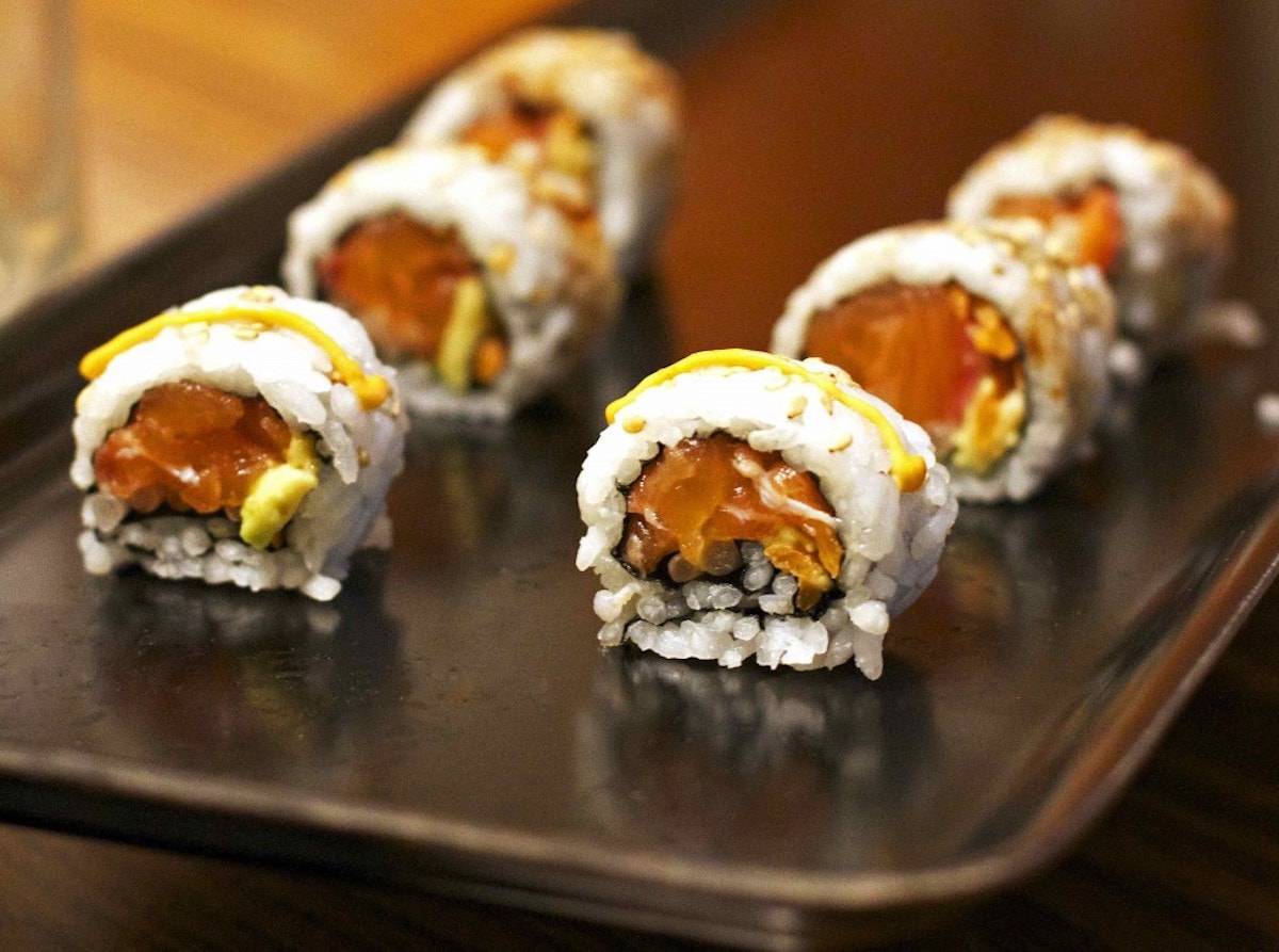 Homemade Sushi on a black platter.