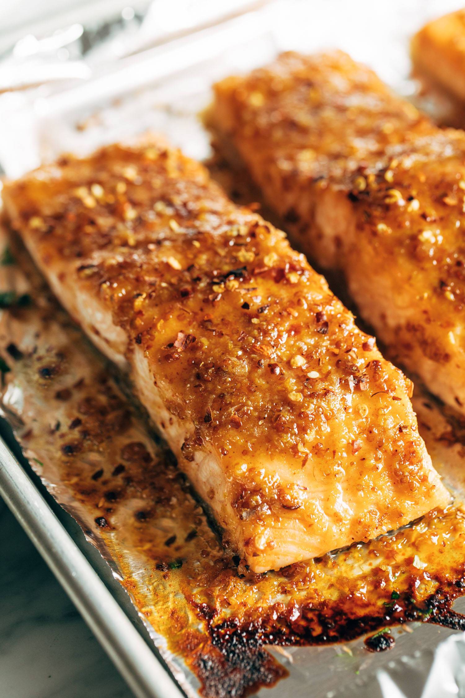 Hot honey salmon on a sheet pan lined with foil. 