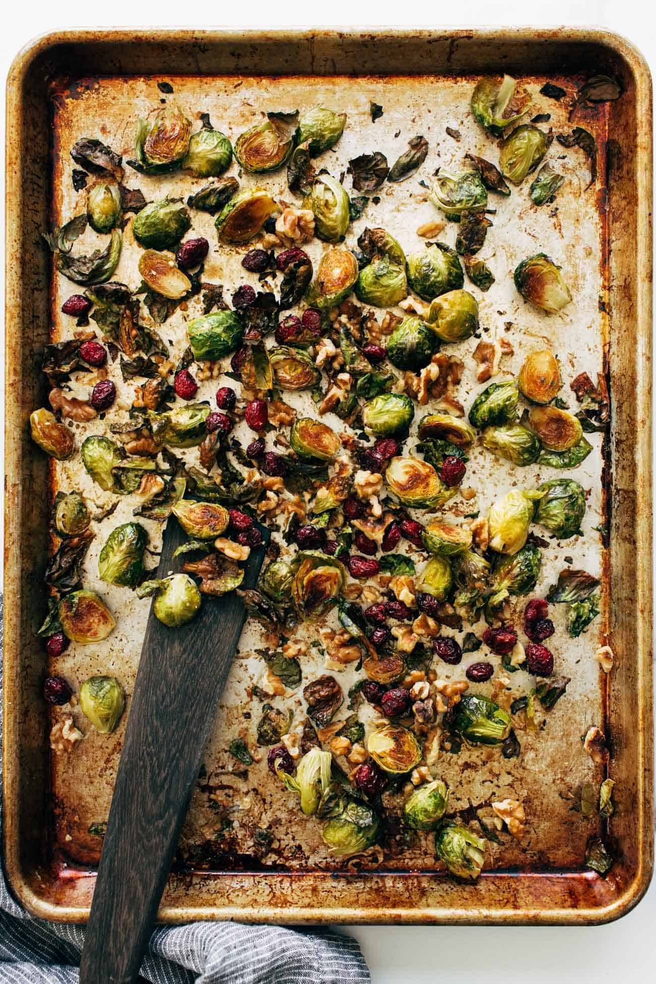Roasted Brussels sprouts on a pan with a spatula