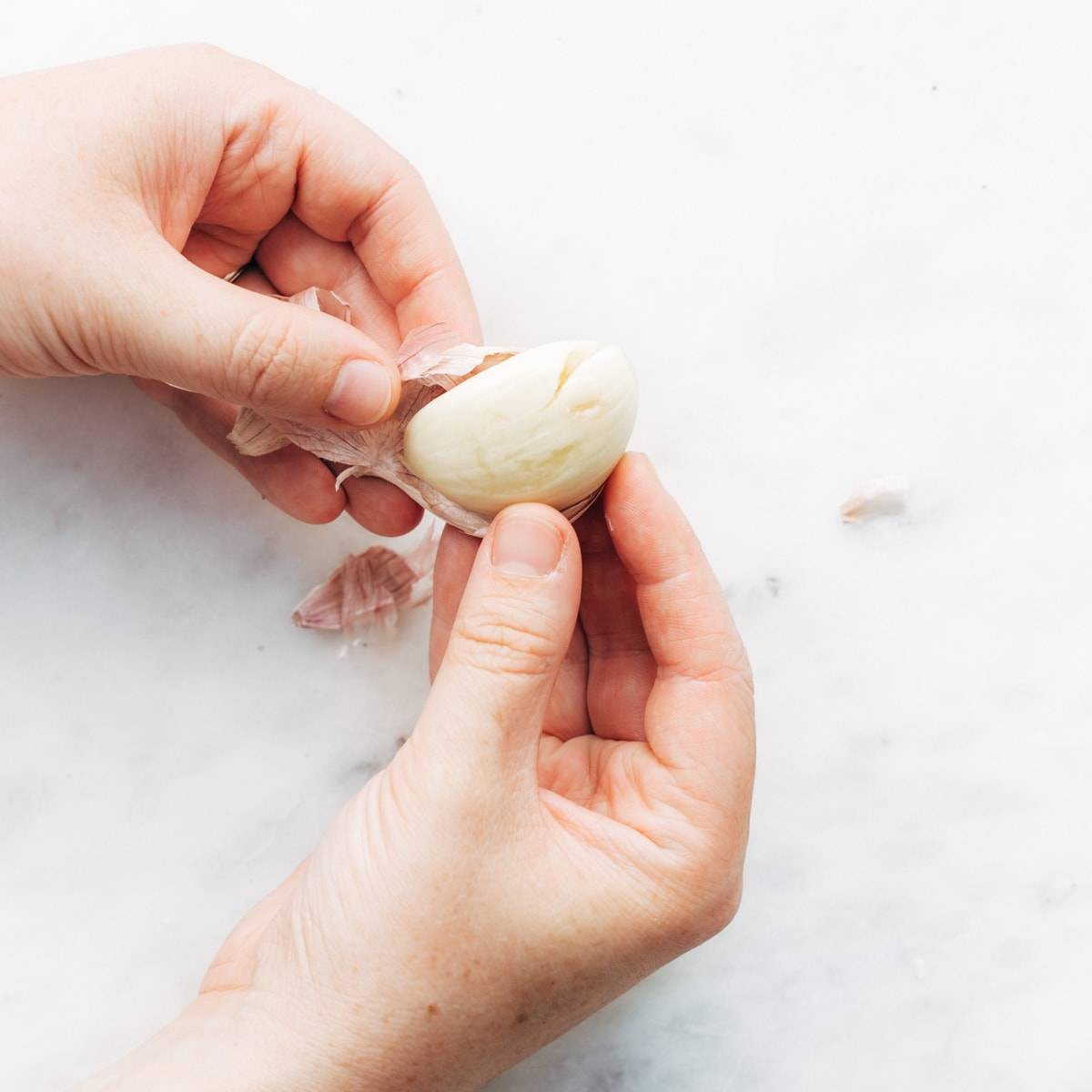 A photo showing how to peel garlic.
