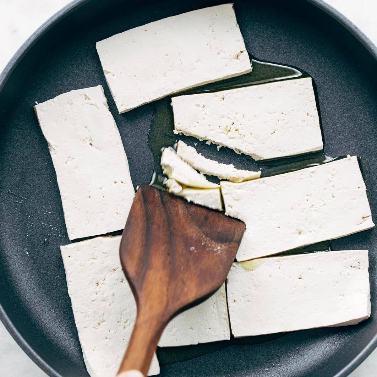 Tofu in a pan with oil.