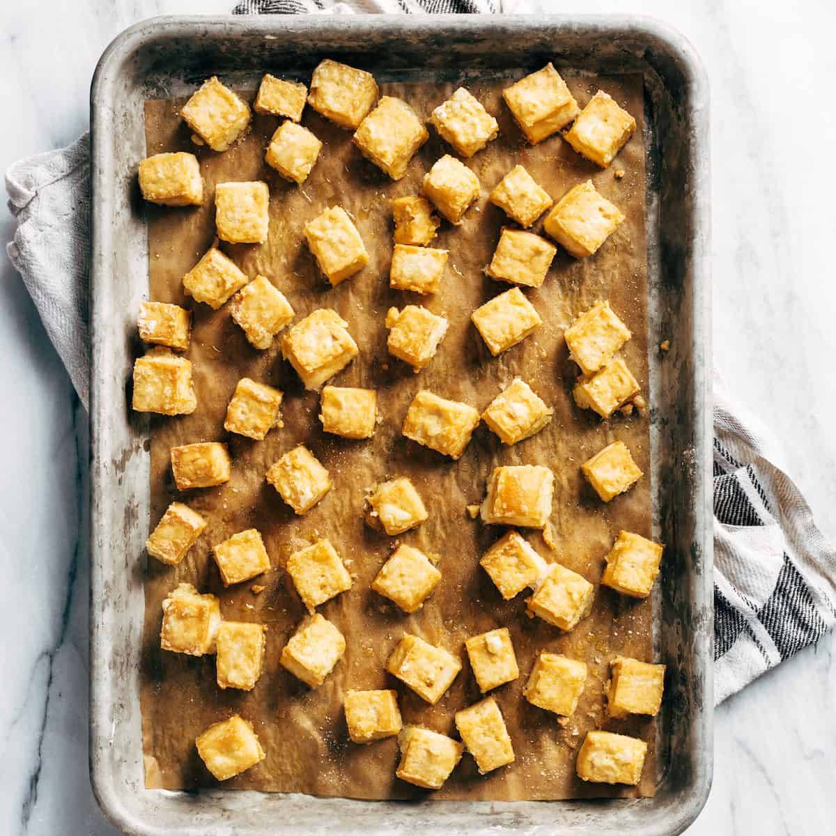 Crispy tofu on a baking sheet after baking.