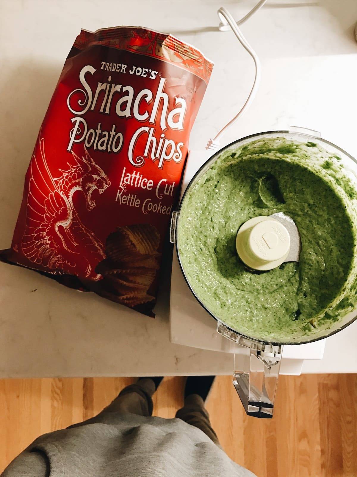 Homemade guacamole with sriracha potato chips on the counter.