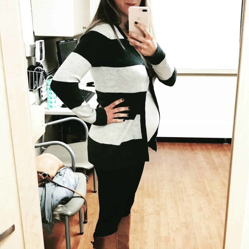 Lindsay taking a photo in a mirror with a baby bump.