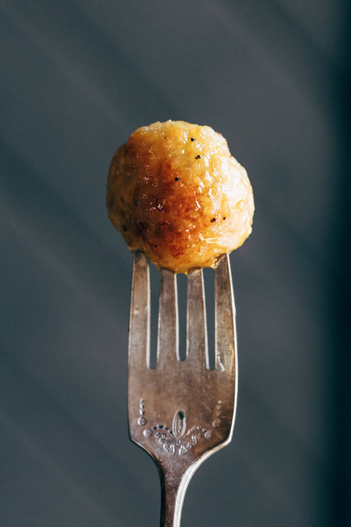 Baked Chicken Meatball on a fork.