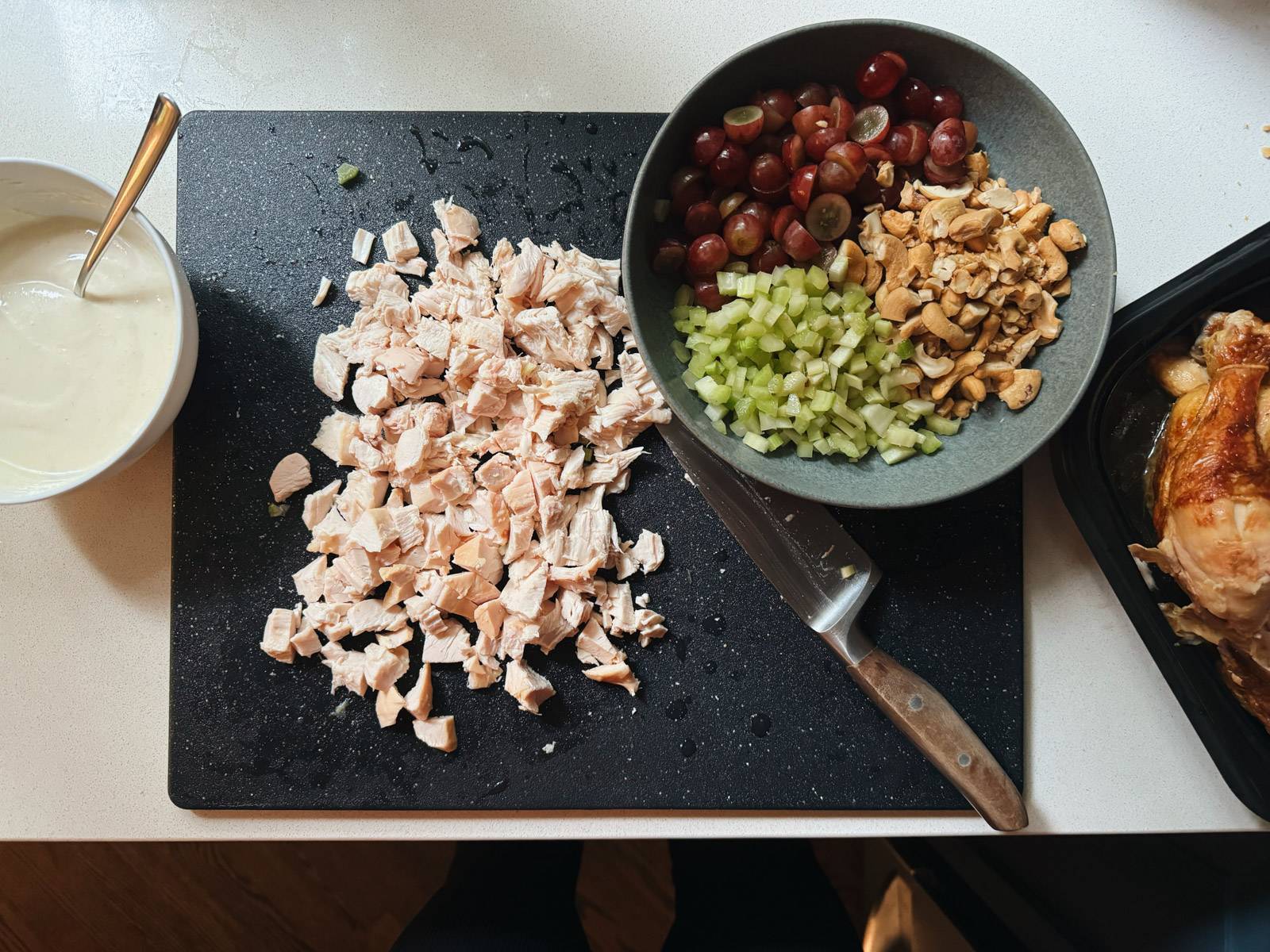 Chopped chicken, grapes, celery, and cashews for chicken salad.