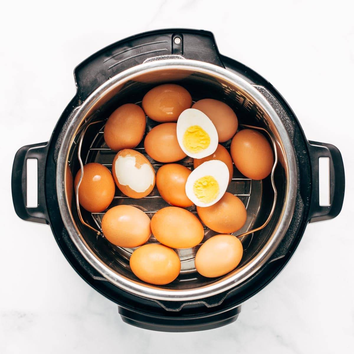 Eggs in the Instant Pot. One egg is cut open and it's hard-boiled. 