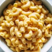 Creamy elbow macaroni and cheese in a white bowl.