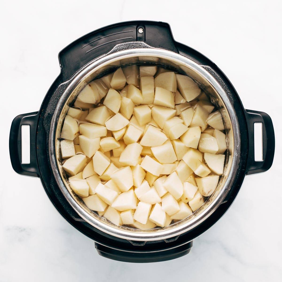 Raw cut potatoes in the Instant Pot.