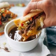 Shredded beef sandwich with au jus in a bowl.