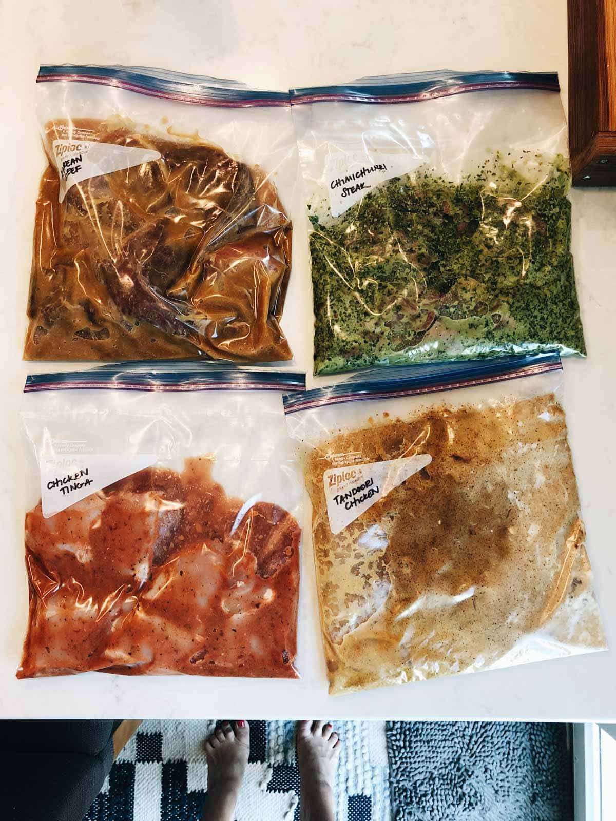 Ziploc bags full of different dishes having labels over them.