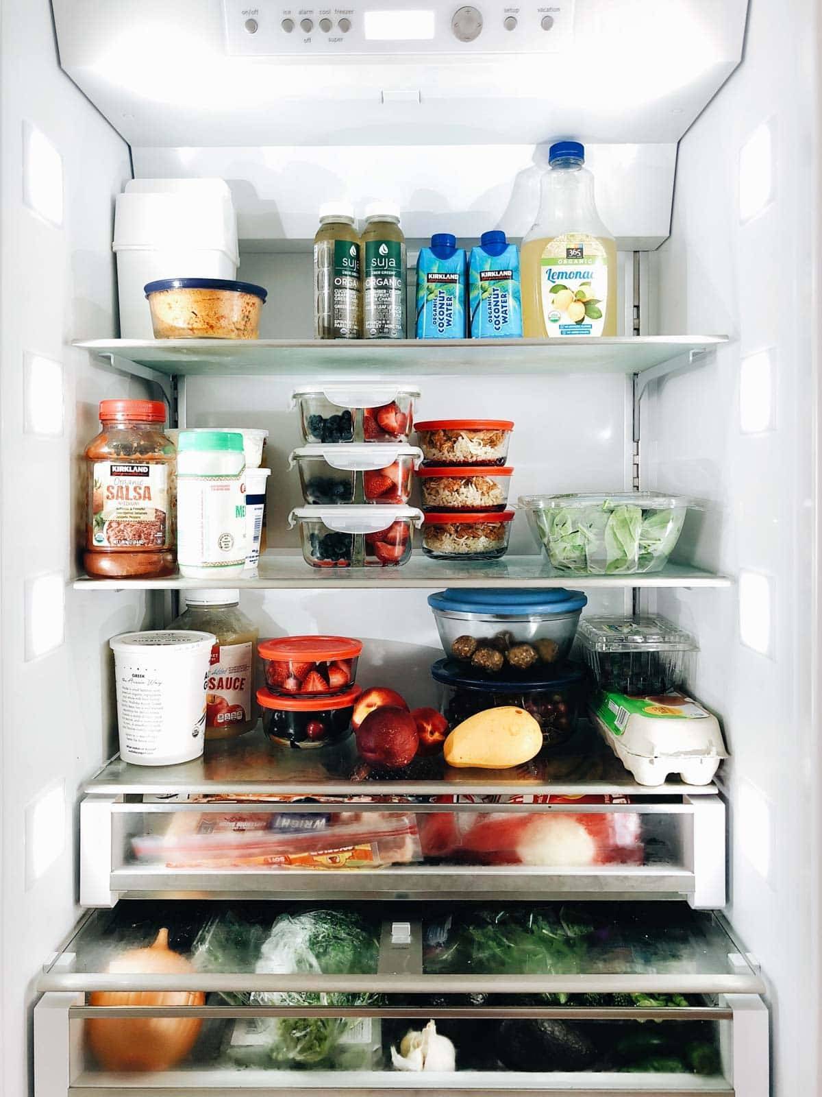 Organized fridge with food.