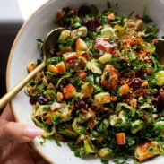 Kale Apple Salad in a bowl with crispy shallots on top.