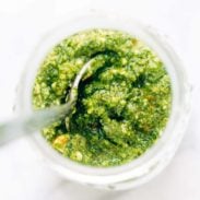 Kale Pesto in a jar with spoon.
