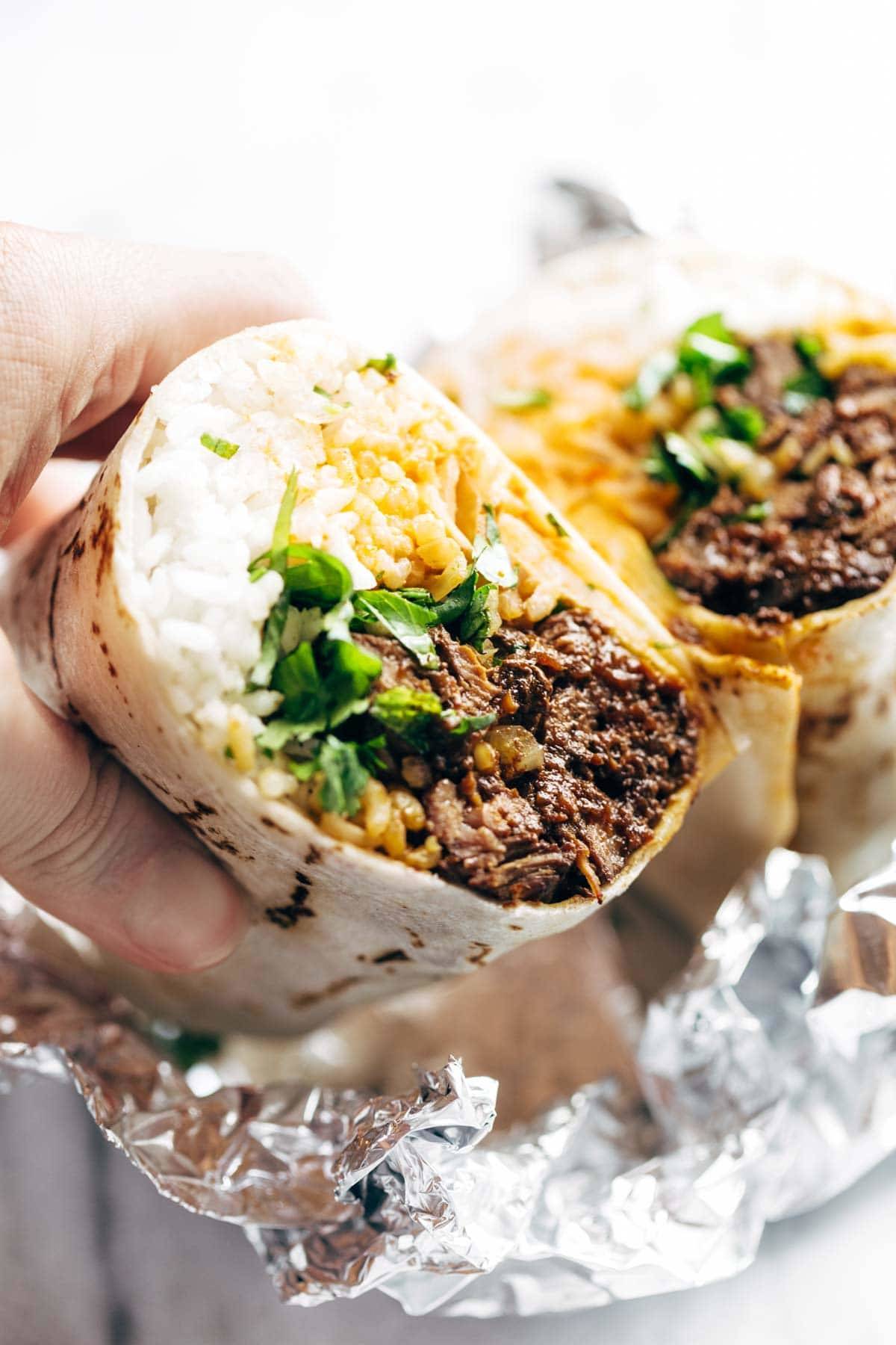 Korean BBQ Burrito - an easy food-truck-style recipe you can make with a slow cooker! spicy beef, kimchi, rice, cilantro, and sriracha mayo in a soft flour tortilla. | pinchofyum.com