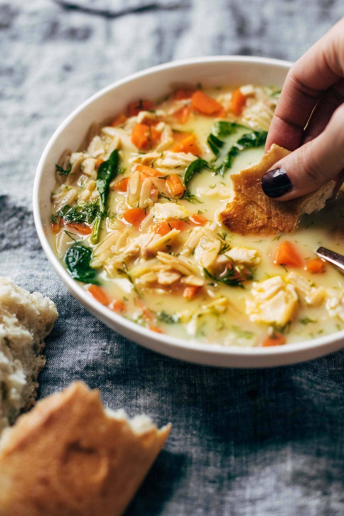 Lemon chicken soup with bread.