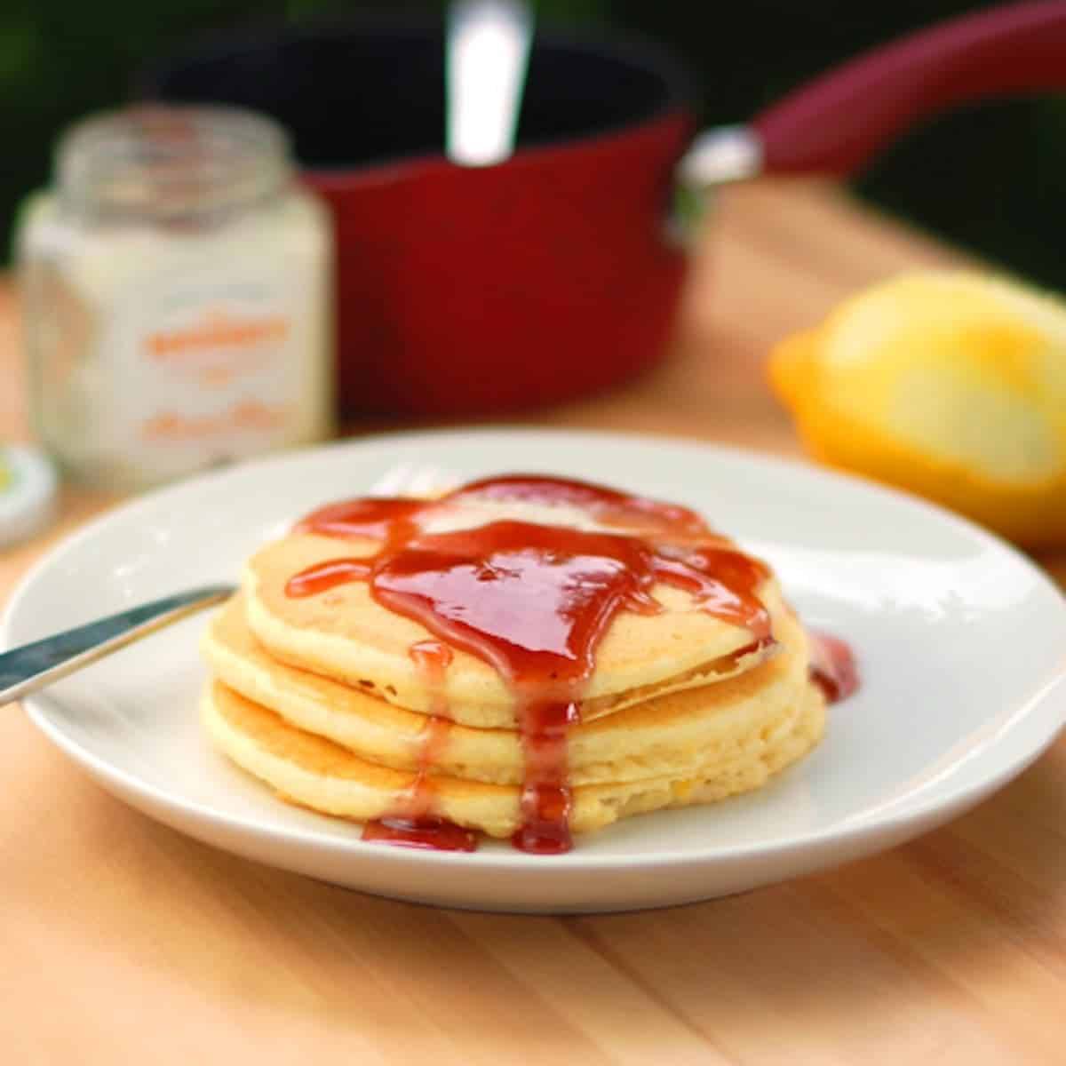 Lemon Pancakes topped with a blackberry syrup made from blackberry jam.