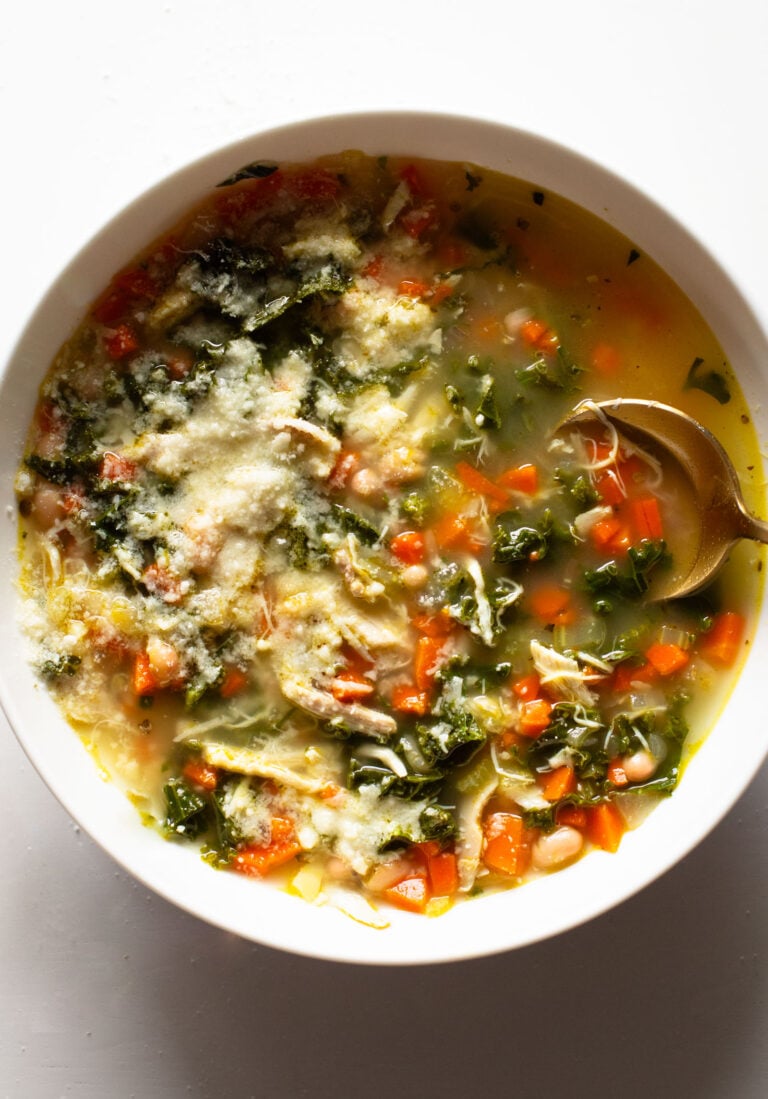 Lemon rosemary chicken soup in a bowl with a spoon.