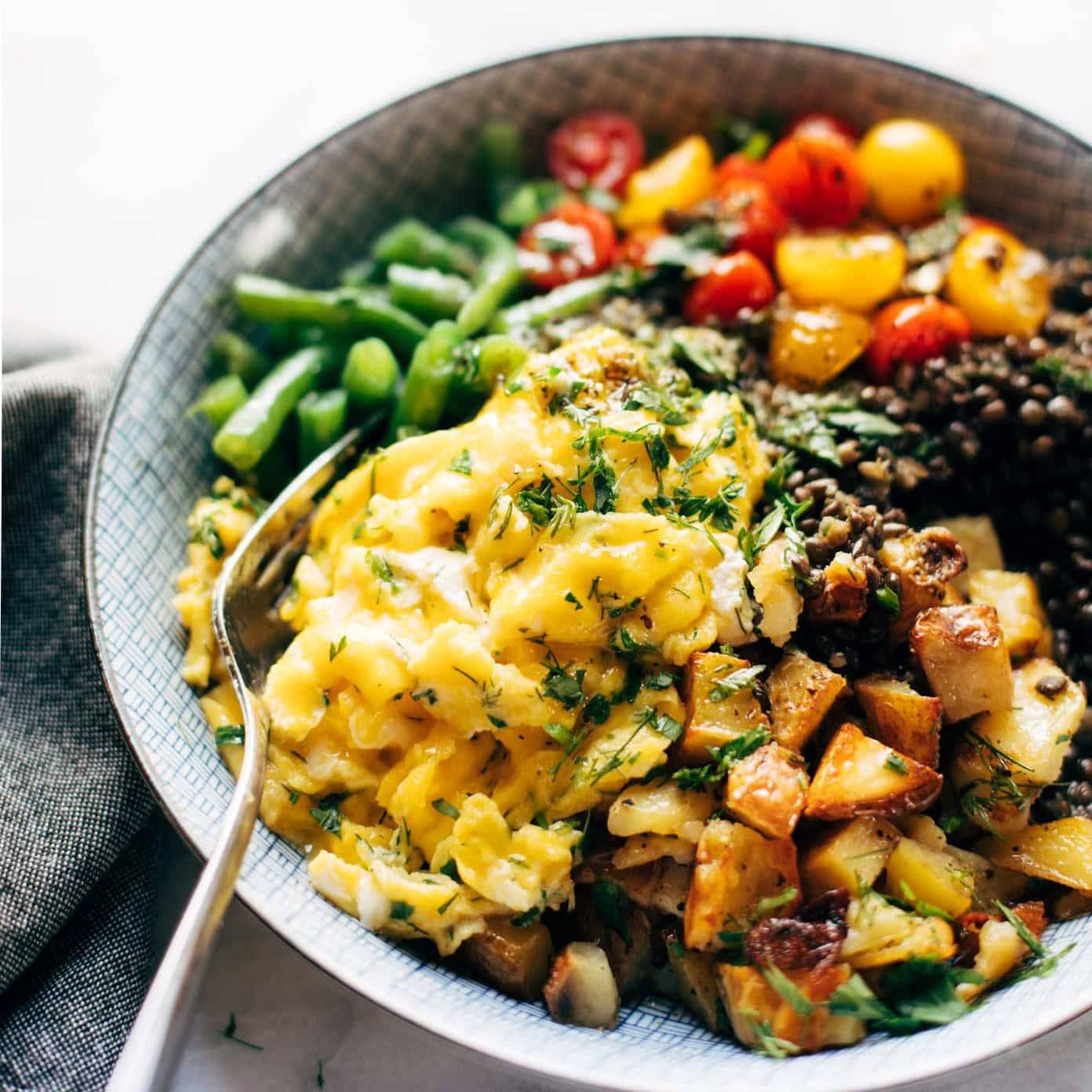 Lentil Bowl with scrambled eggs, potatoes, green beans, and tomatoes.