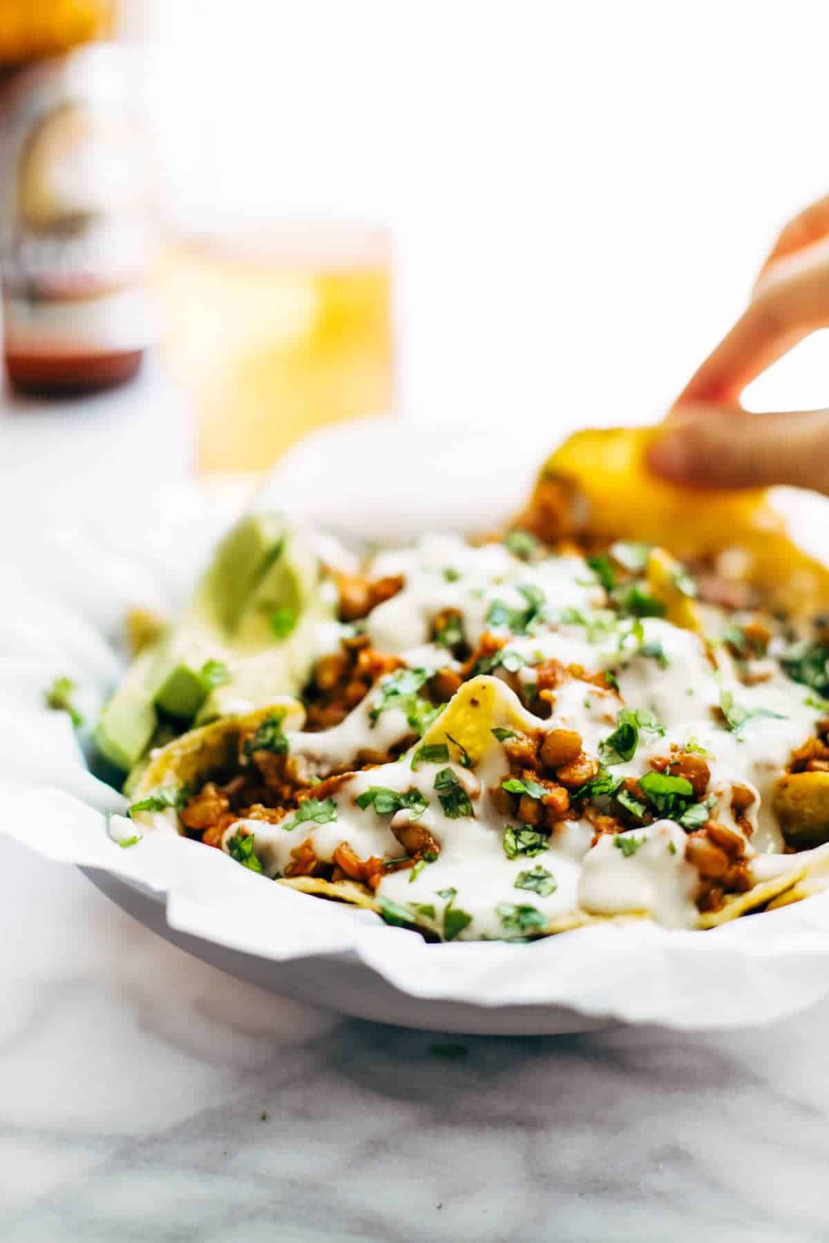 Spicy Lentil Nachos with Three Cheese Sauce - you will not believe how good these are! Saucy filling with a velvety homemade cheese sauce. Vegetarian. | pinchofyum.com