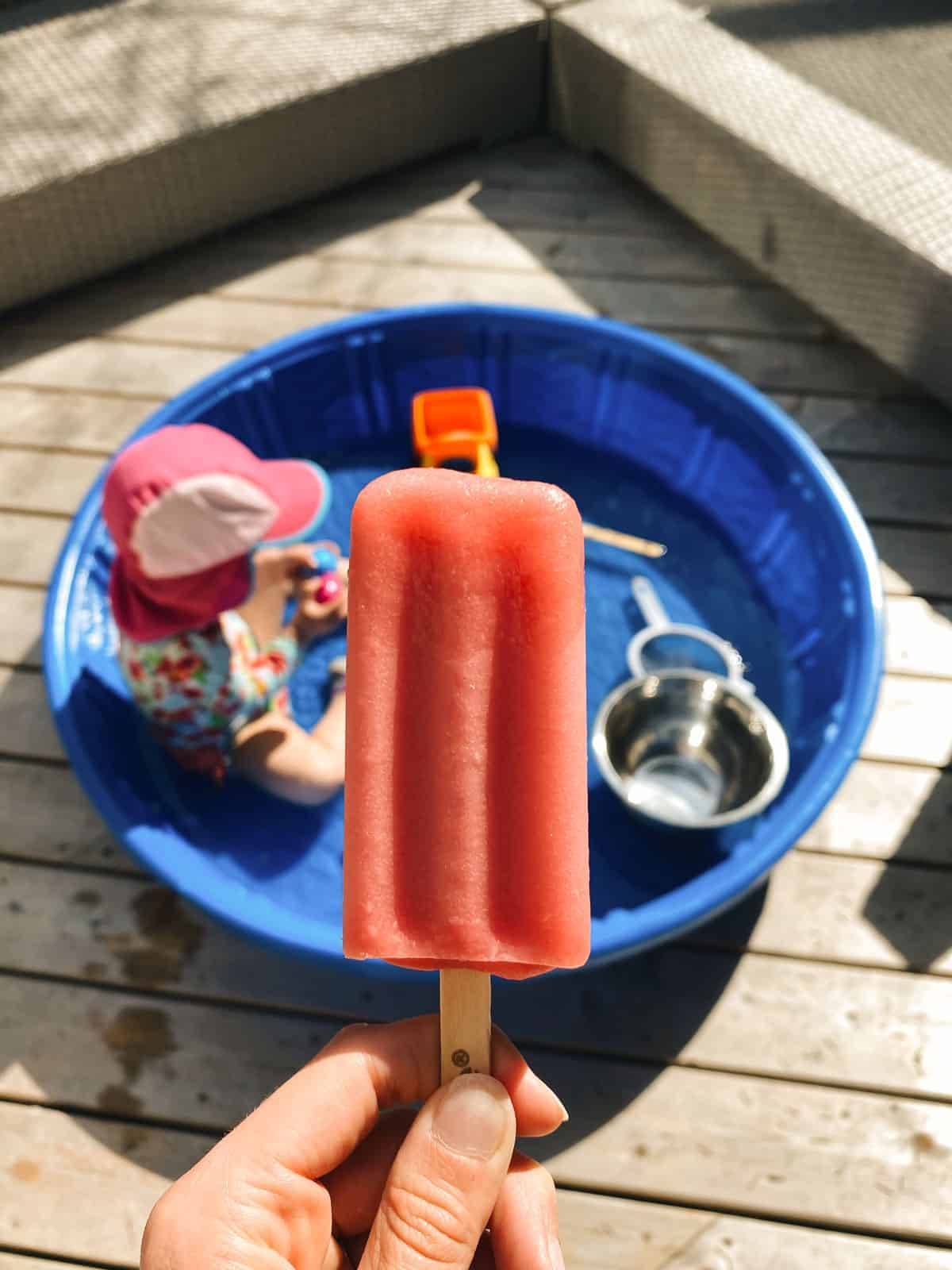 A person holding a popsicle.