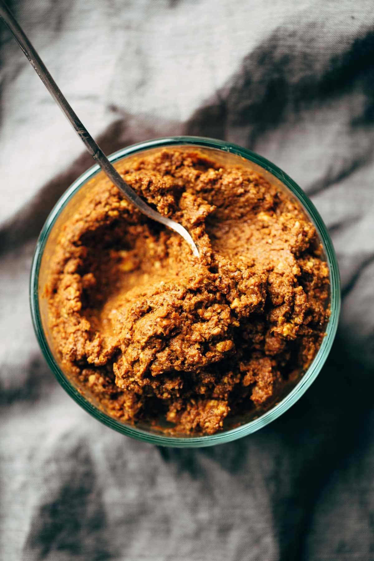 Masala sauce in a bowl with a spoon.