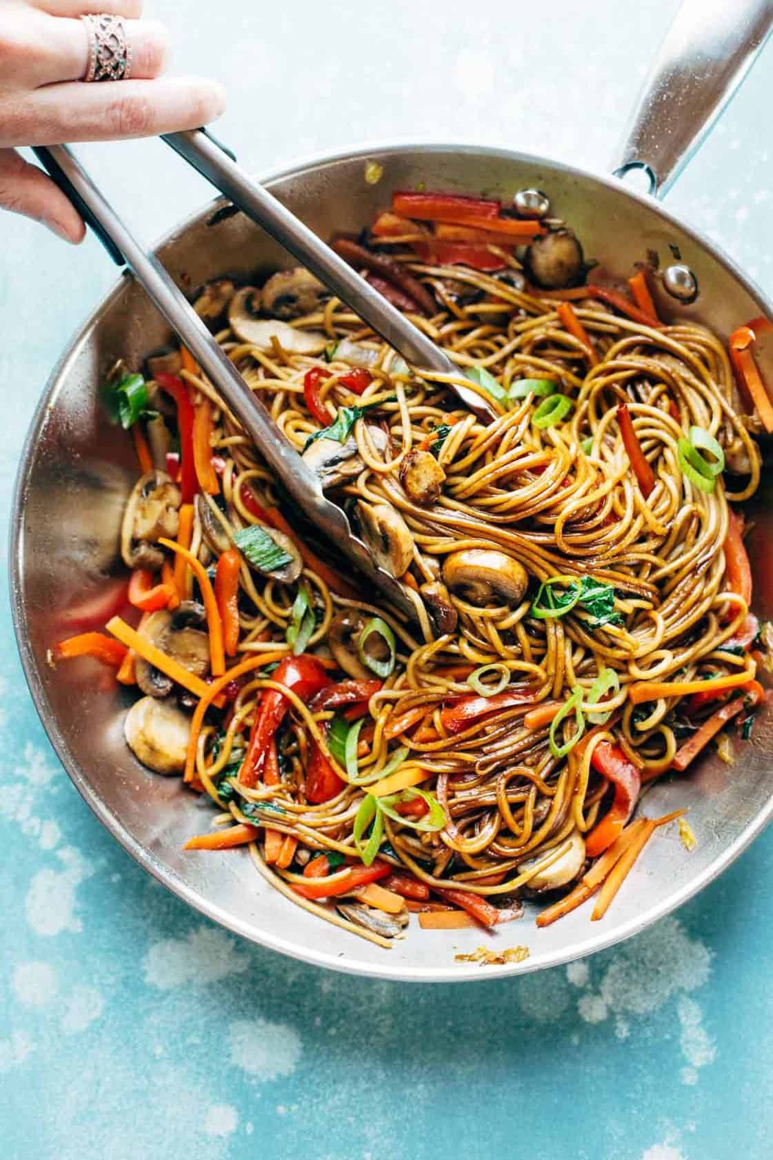 Lo Mein in pan with tongs.
