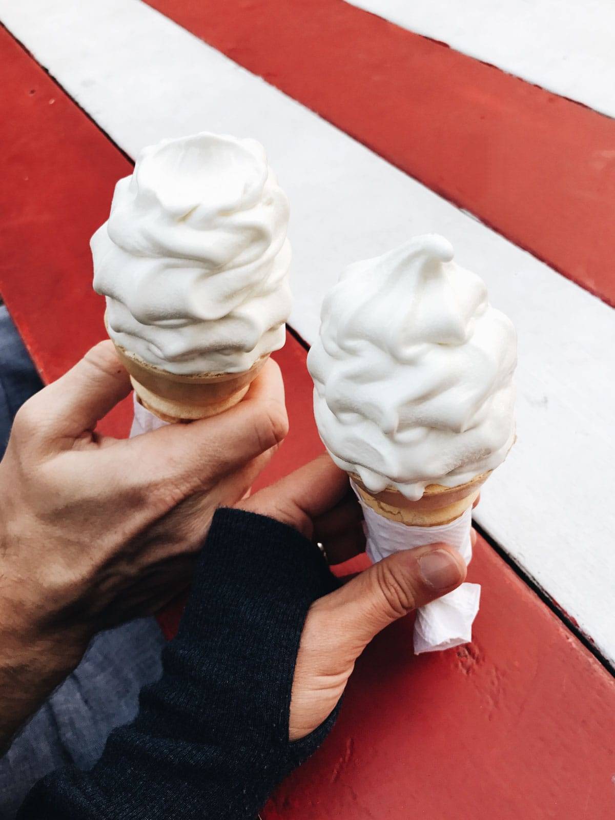Two vanilla ice creams in a cone