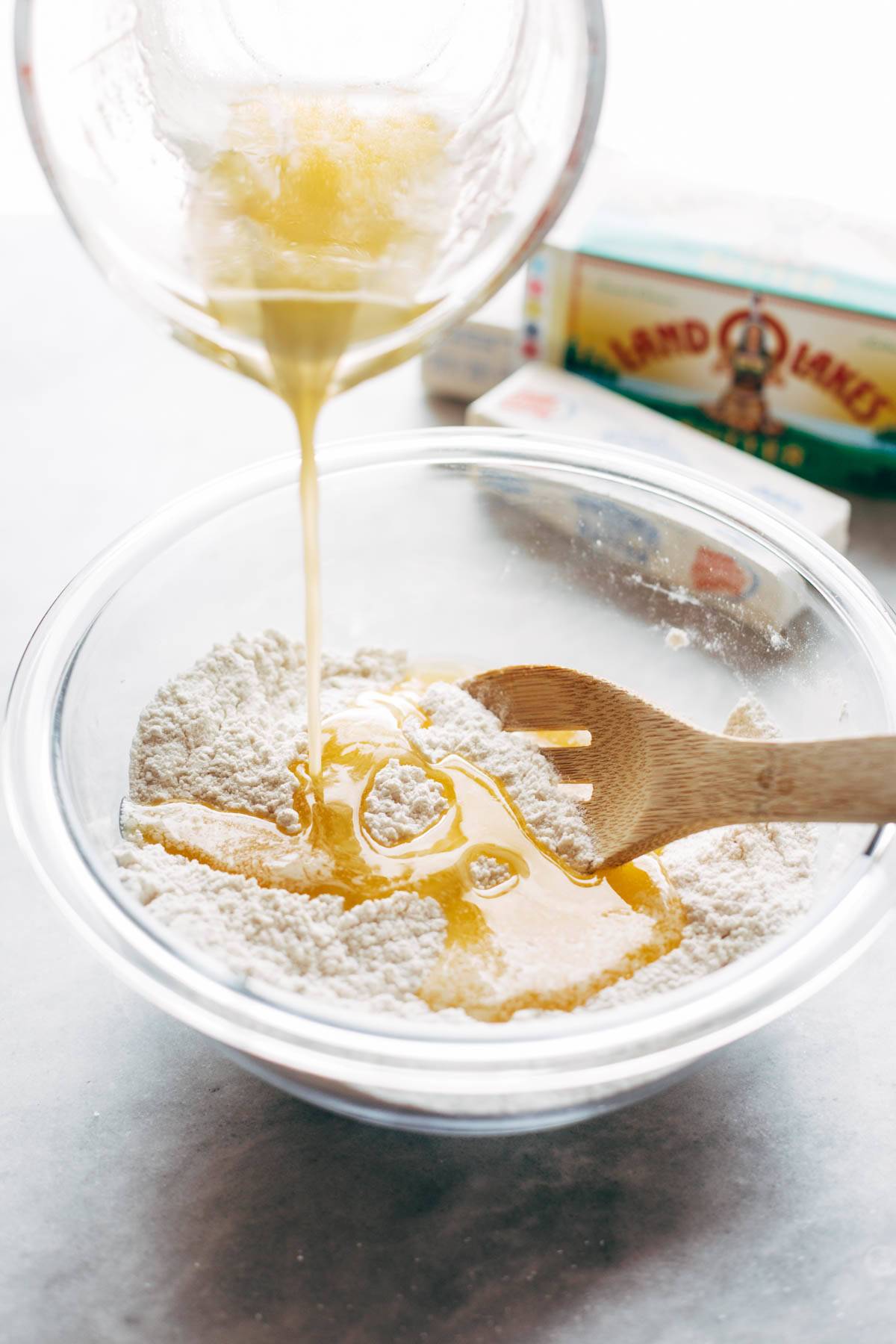 Melted butter poured into bowl with flour.