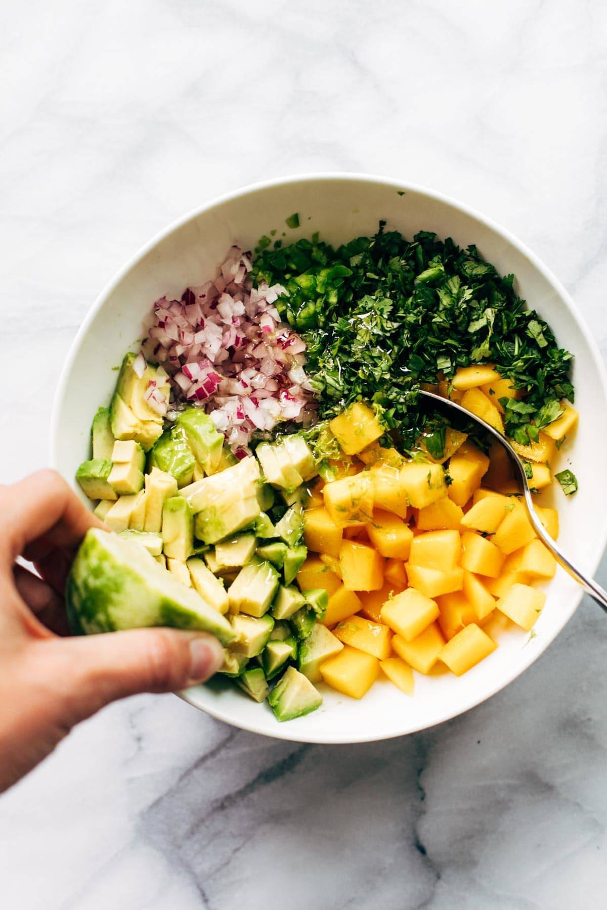 Ingredients for mango salsa in a bowl.