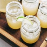Margaritas for a Crowd in mason jars with lime.