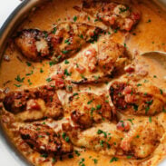 Marry Me Chicken in a pan with a spoon.