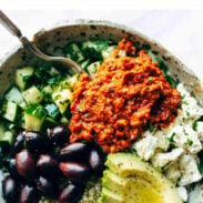 Mediterranean quinoa bowls with red pepper sauce.