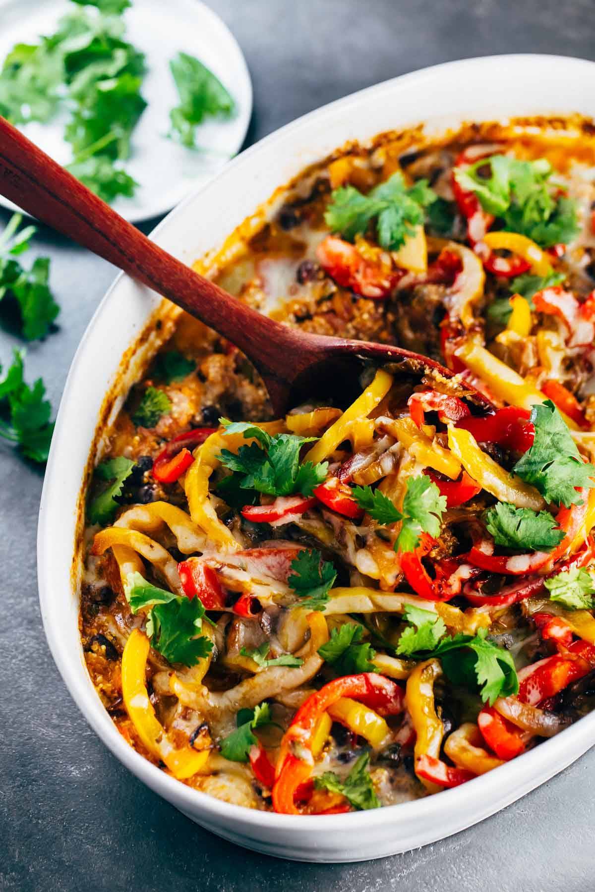 Mexican Chicken Quinoa Casserole in a baking dish with a wooden spoon.