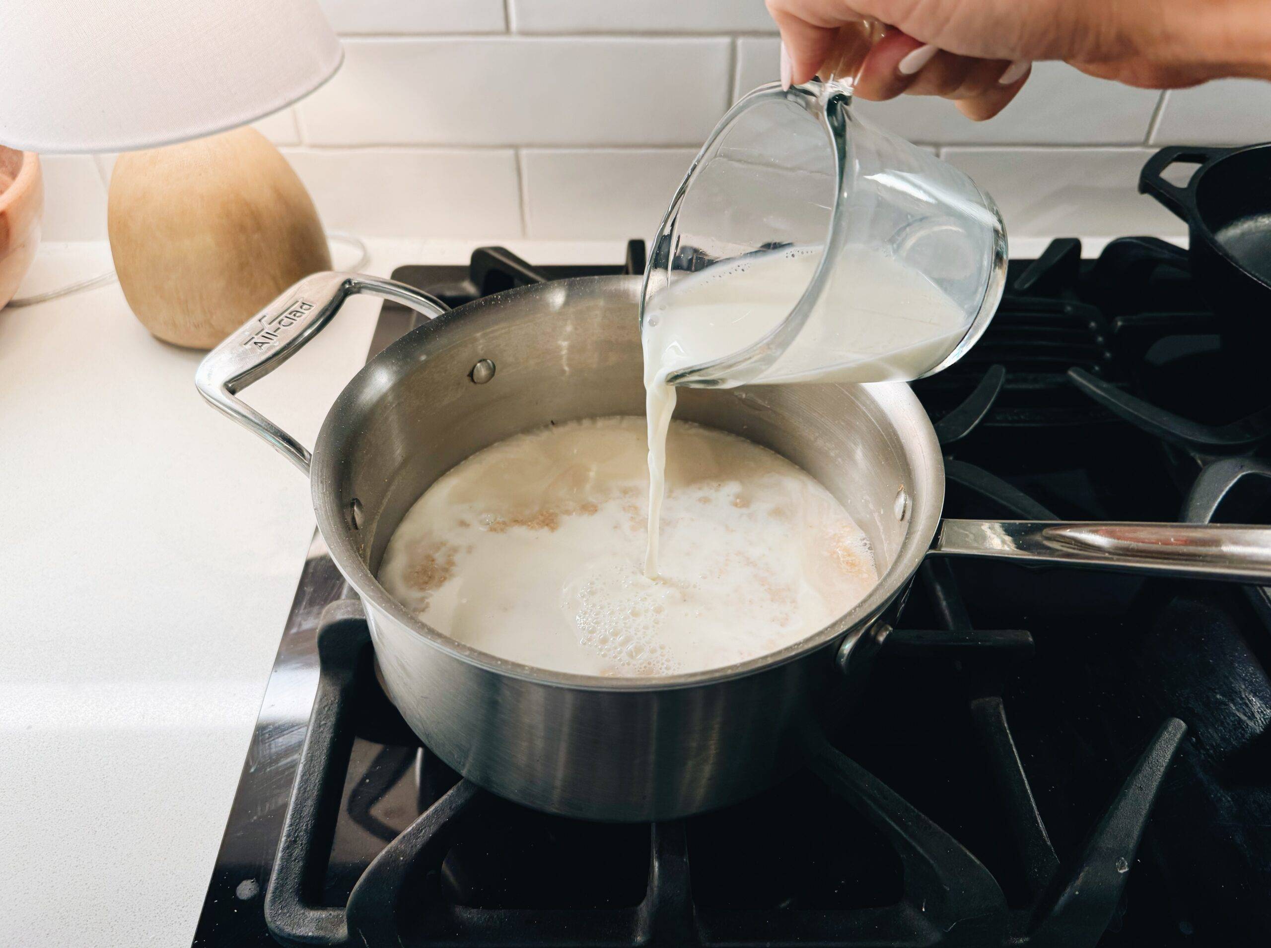 Pouring milk into a pot of oat bran.