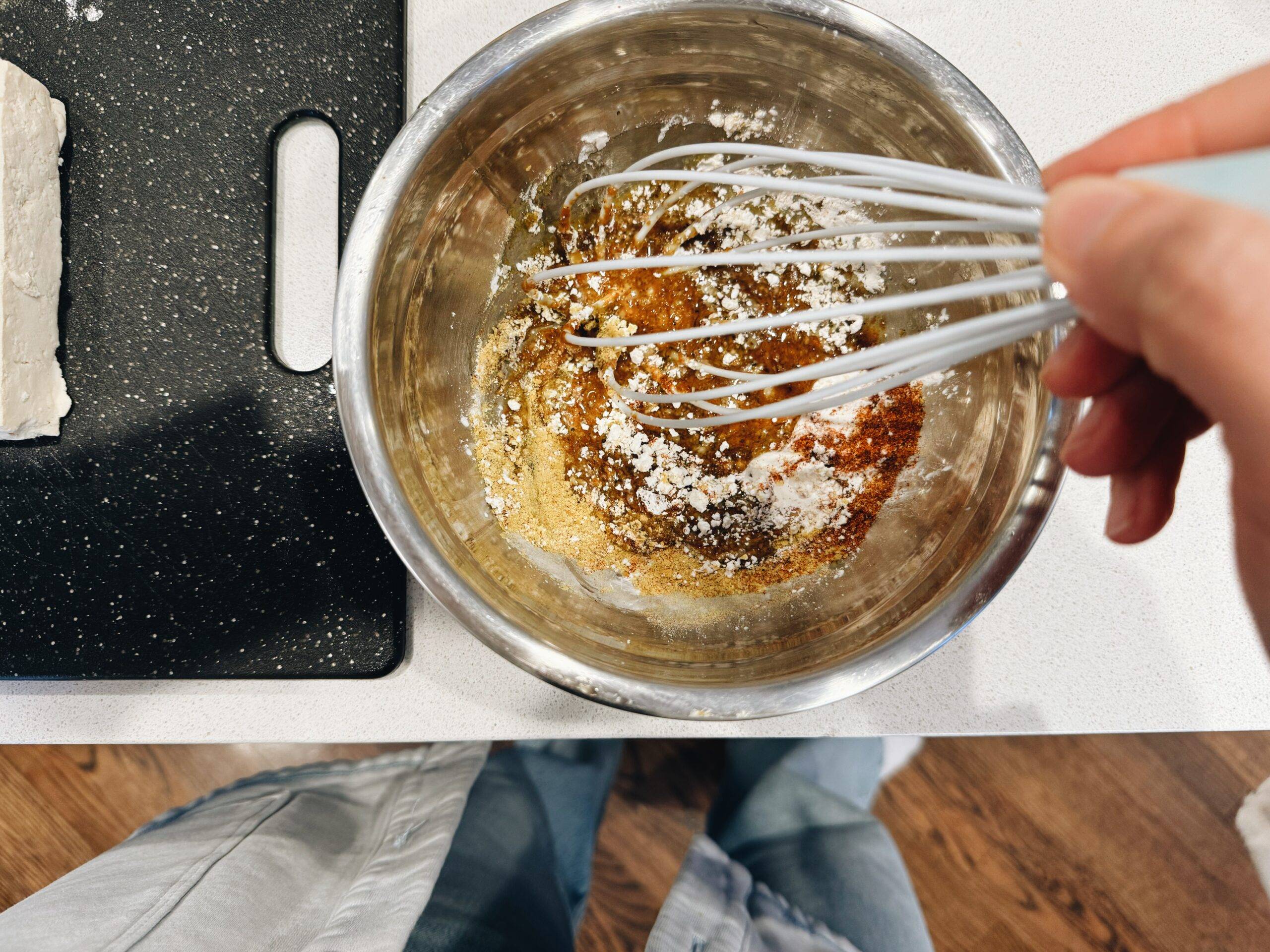 Whisking up spices in a bowl.