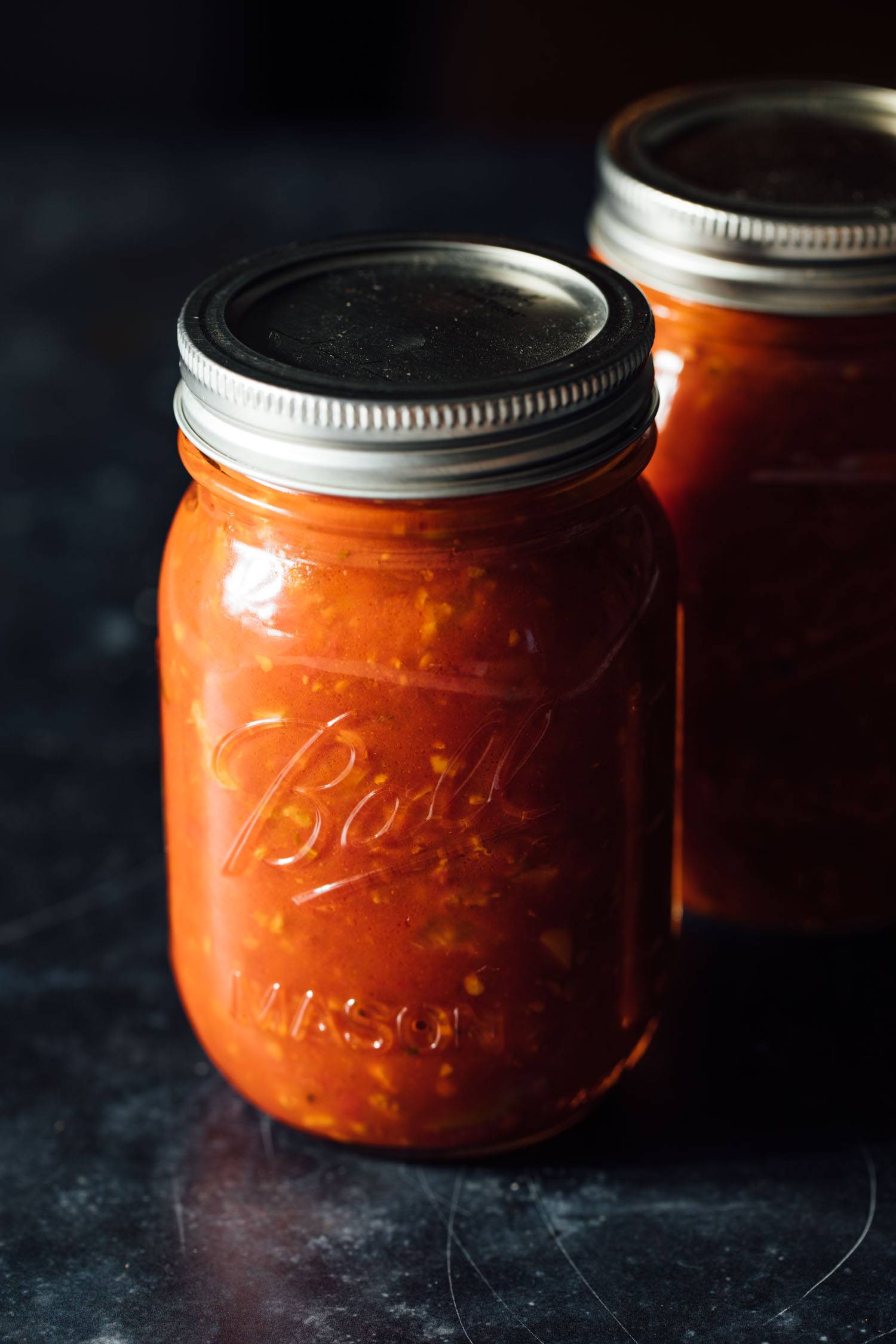 Red sauce in two mason jars.